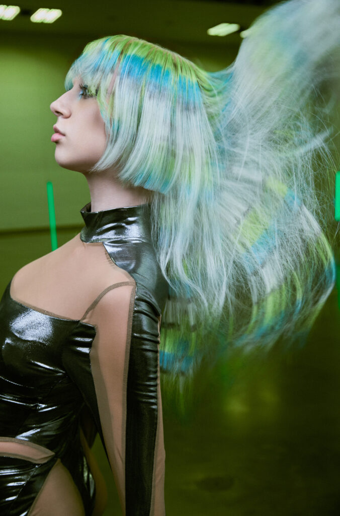 A close-up shot focusing on the precision of a professional stylist using shears and a comb on wet hair during a professional hair education workshop.