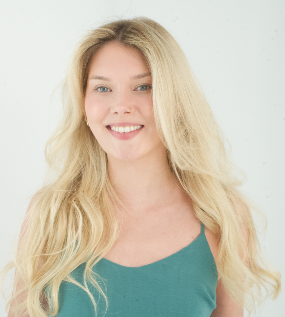 A close-up of a model's hair showing soft separation and touchable volume created by Aveda Tousle Texture Dry Spray.