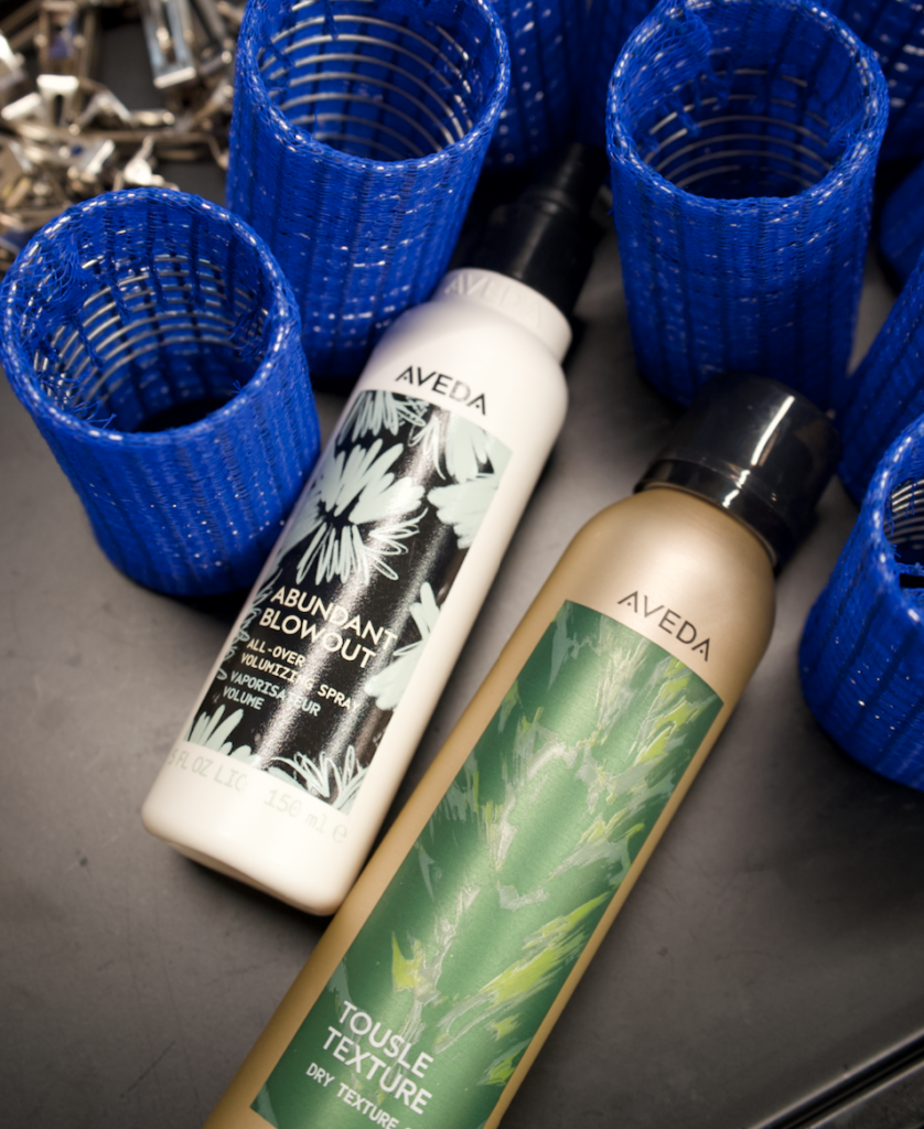 Close-up detail of hair texture showing the soft separation and grit provided by Aveda Tousle Texture Dry Spray.